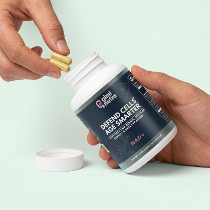 Person holding giminutra's NAD+ supplement bottle and two capsules on a mint green background. 