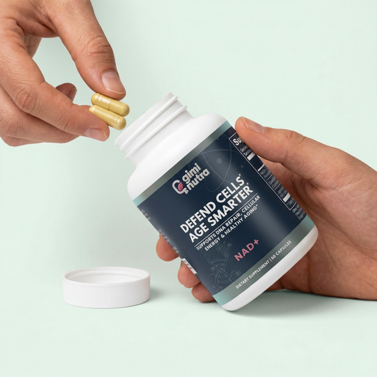 Person holding giminutra's NAD+ supplement bottle and two capsules on a mint green background. 